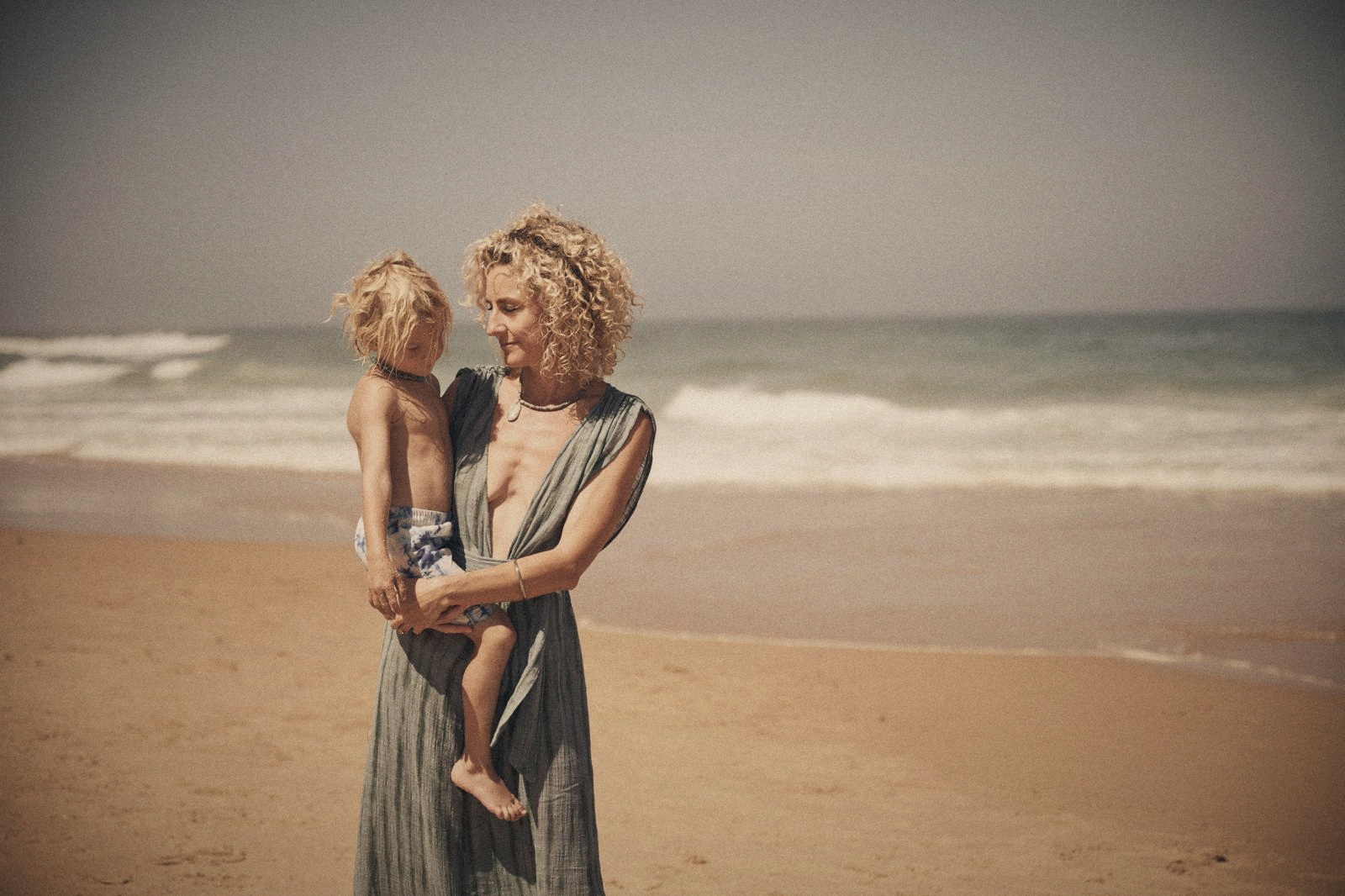 Karin holding her son at the sea