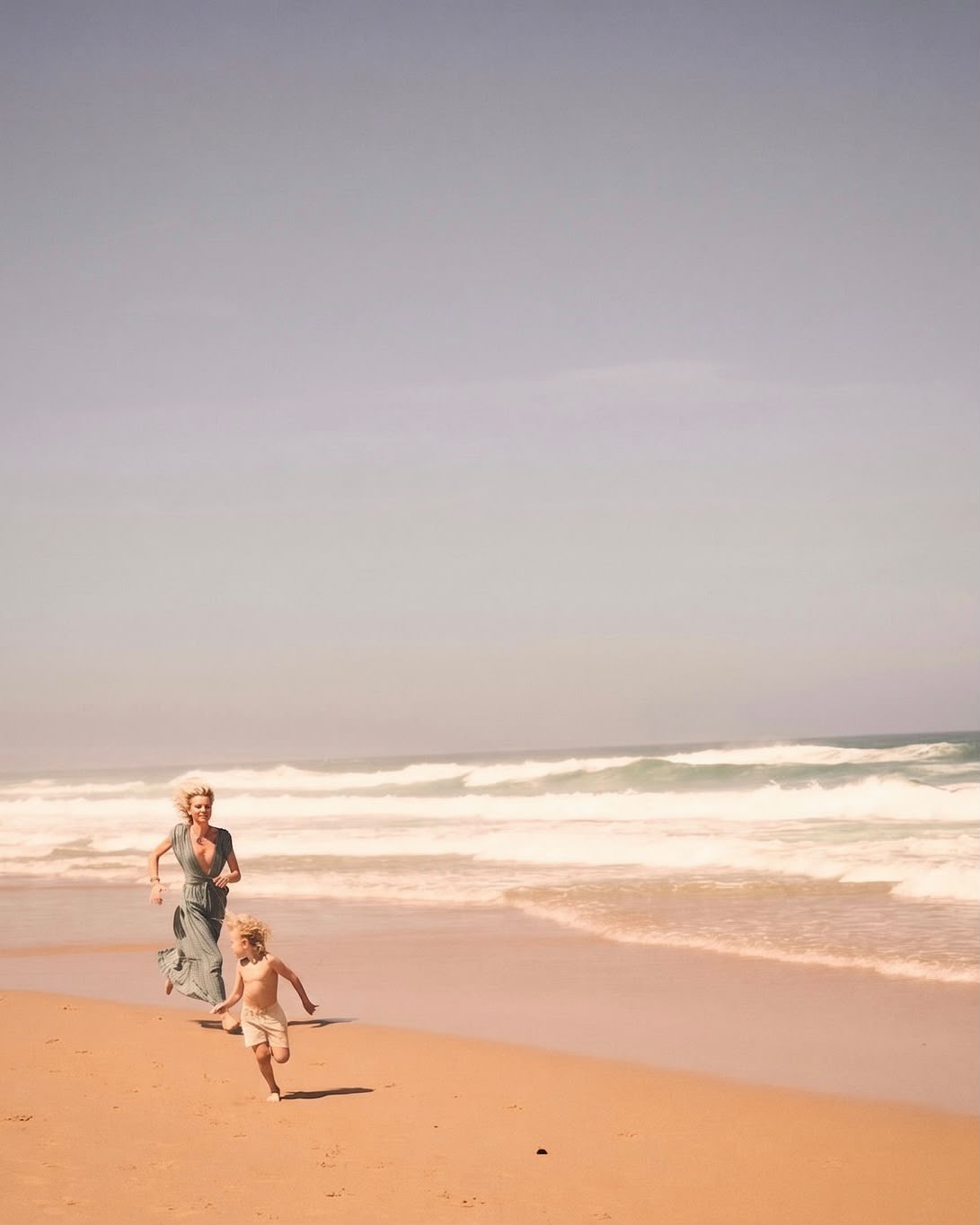 Karin running along the shoreline with her son
